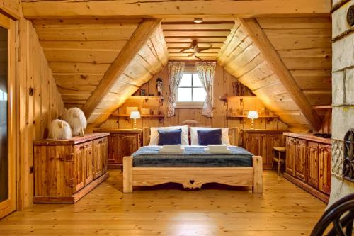 una camera da letto in legno con letto e pareti in legno di Chata Góralska Exclusive SPA - Lipowa Beskidy a Lipowa