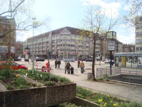 a group of people walking down a city street at Hotel am Karlstor in Karlsruhe