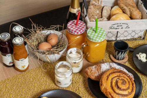 a table with a bunch of different types of bread and drinks at Ariane's Guesthouse in Sesto