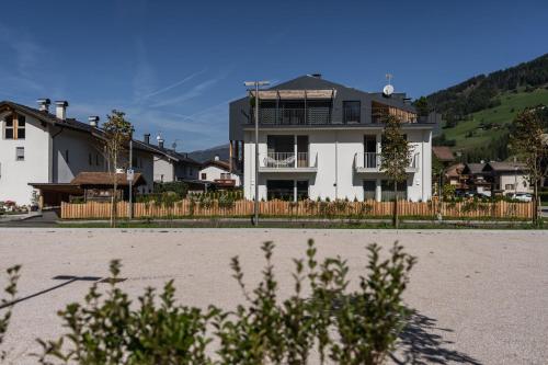 a large white house with a fence in front of it at Ariane's Guesthouse in Sesto