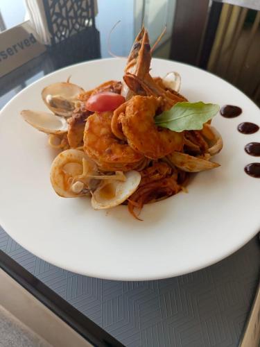 a white plate of food on a table at Hill Top Muscat in Muscat
