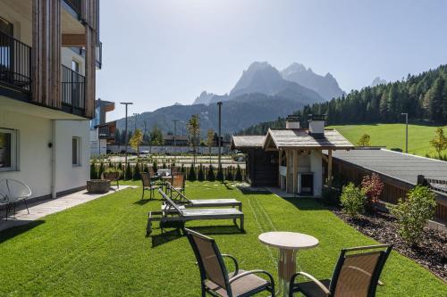 a patio with a table and chairs on the grass at Ariane's Guesthouse in Sesto
