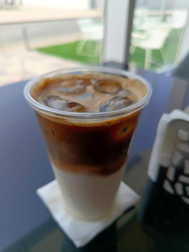 a cup of coffee sitting on top of a table at Hill Top Muscat in Muscat