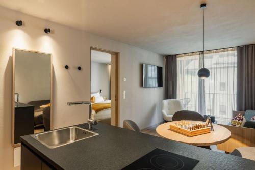 a kitchen with a table and a living room at Ariane's Guesthouse in Sesto