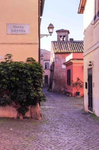 an empty street in an old town with buildings at Felici’s apartment agli scavi di Ostia Antica in Ostia Antica