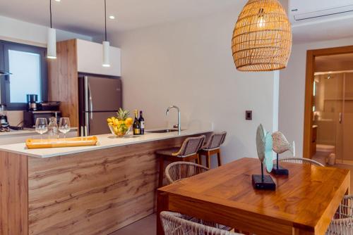 a kitchen with a wooden counter and a wooden table at Stylish and spacious penthouse with Bbq and picuzi in Punta Cana