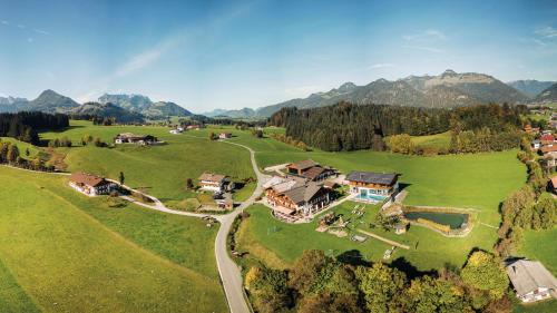 an aerial view of a house on a green field at Feriengut Unterhochstätt in Schwendt