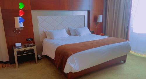 a bedroom with a large bed with a large headboard at Stunning 3-Bedrooms GuestHouse in Limbe Cameroon in Limbe