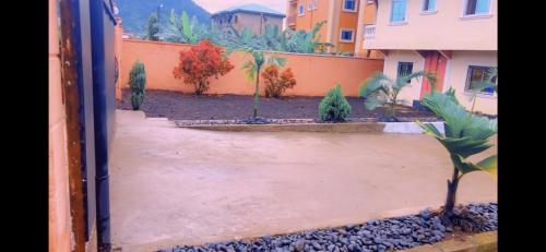 a view of a courtyard with trees and buildings at Stunning 3-Bedrooms GuestHouse in Limbe Cameroon in Limbe