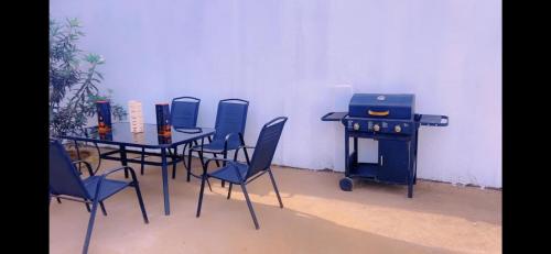 a room with a table and chairs and a grill at Stunning 3-Bedrooms GuestHouse in Limbe Cameroon in Limbe