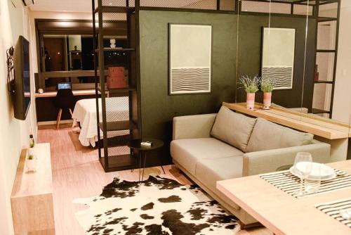 a living room with a couch and a bunk bed at Studio 308 no Parque Una com garagem in Pelotas