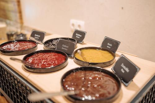 a group of four pans of food on a stove at Feriengut Unterhochstätt in Schwendt