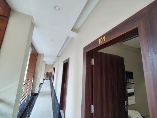 a hallway with a door in a building at Hotel Kusum Palace in Gaya
