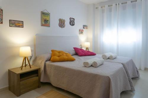 a bedroom with a bed with towels on it at Estupendo apartamento en el grao in Gandía