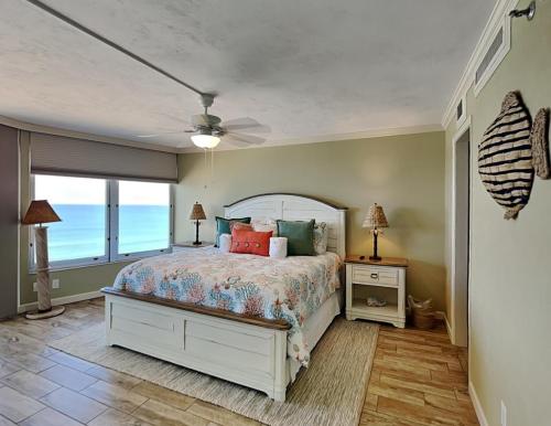 a bedroom with a bed and a ceiling fan at Oceanside Retreat 804 in Ormond Beach