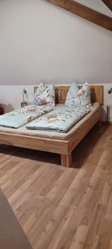 a bed sitting on top of a wooden floor at Appartement Gertraud in Hieflau