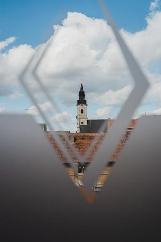a building with a clock tower in the background at Caro Boutique Hotel in Oradea
