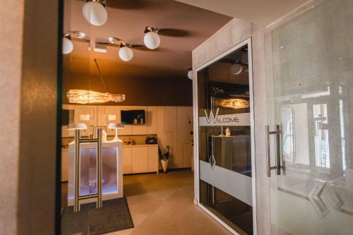 a view of a kitchen from the hallway of a house at Caro Boutique Hotel in Oradea