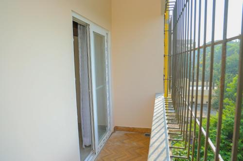 a room with a balcony with a ladder and a window at Swayamkrushi 4th floor in Hyderabad