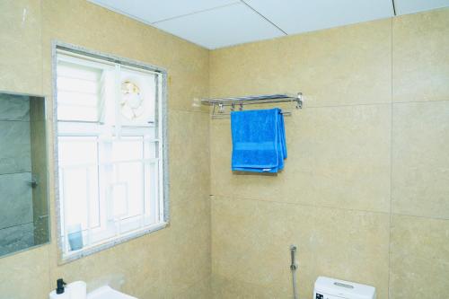 a bathroom with a shower with a blue towel at Swayamkrushi 4th floor in Hyderabad