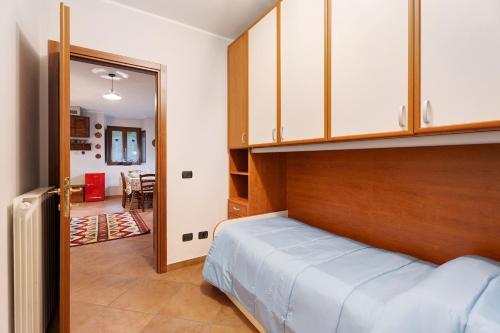 a bedroom with a bed with a wooden headboard at Niky in Anzino