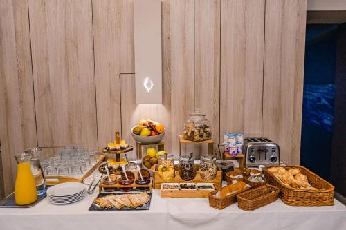 a table with a buffet of food on it at Caro Boutique Hotel in Oradea