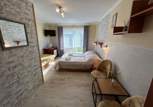 a hotel room with a bed and a couch at Ostrzycka Gościna u Maryli in Ostrzyce