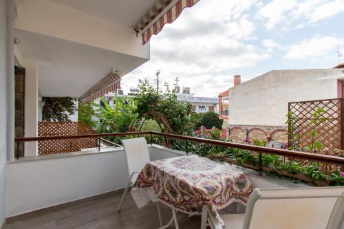 a balcony with a table and chairs on it at STAR PARADISE Studios in Neos Marmaras