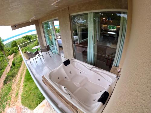 a bath tub in a room with a view at Lasuiza Suites in San Bernardino