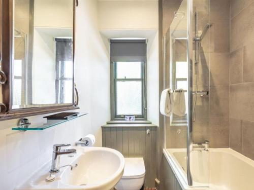 a bathroom with a sink and a toilet and a shower at Gate Lodge in Fettercairn