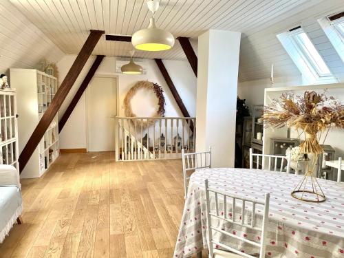 a attic room with a bed and a staircase at Chez Régine, 45m2 privés in Schiltigheim