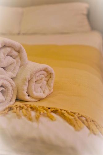a pile of towels sitting on a bed at Apartament Garbary22 in Bydgoszcz