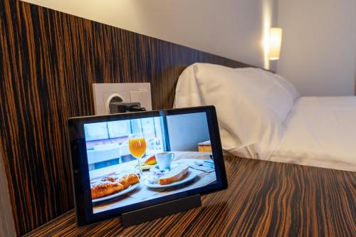a computer monitor sitting on a table in a hotel room at ETH Rioja in Haro