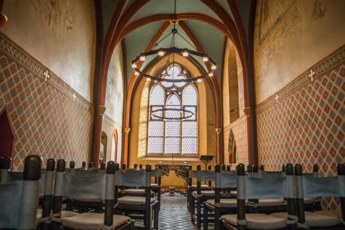 a large room with chairs and a large window at Erbacher Hof, Bistum Mainz in Mainz