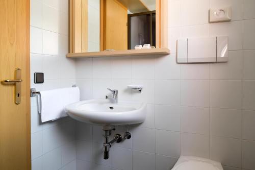 a bathroom with a sink and a toilet at Apartments Lores in Selva di Val Gardena