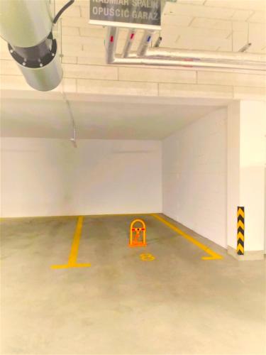 an empty parking garage with yellow lines on the floor at Apartament Garbary22 in Bydgoszcz
