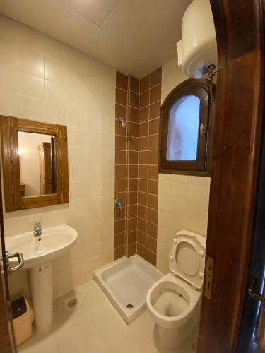 a bathroom with a toilet and a sink at Dahab , property company Lighthouse area in Dahab