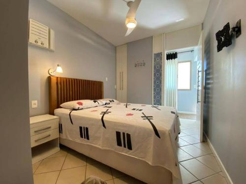 a bedroom with a large bed and a bathroom at Ocean Flat 1006 in Vila Velha