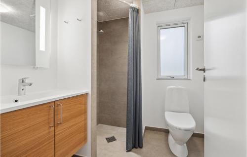 a bathroom with a toilet and a sink and a window at Aqua 242 in Krakow am See