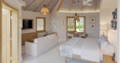 um quarto com uma cama branca e uma televisão em Sandals Royal Curacao All Inclusive Couples Only em Nieuwpoort
