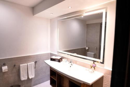 a bathroom with a sink and a large mirror at Sentido Akassia Beach in Quseir