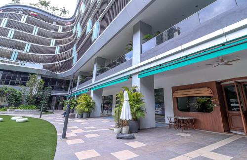 a building with a patio with a table and a umbrella at 10 min to My town family unit By Nexx Field in Kuala Lumpur
