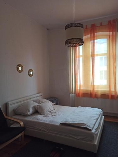 a bedroom with a bed and a window with a light at Private room in a shared apartment, free parking in Fulda