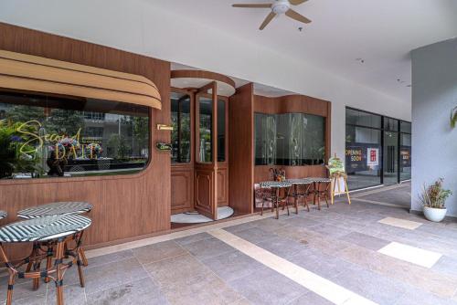 a restaurant with chairs and a table and windows at 10 min to My town family unit By Nexx Field in Kuala Lumpur