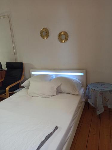 a bed in a room with two mirrors on the wall at Private room in a shared apartment, free parking in Fulda