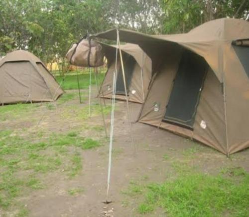 a group of tents parked in a field at Camping Magamba Forest in Lushoto