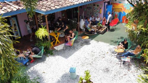 a group of people sitting outside of a building at Yolo Hostel Medellin in Medellín
