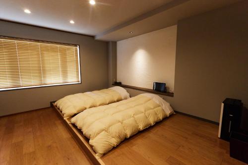 a large bed in a room with a large window at Stay UWU 001 ステイ ウー 001 in Kochi