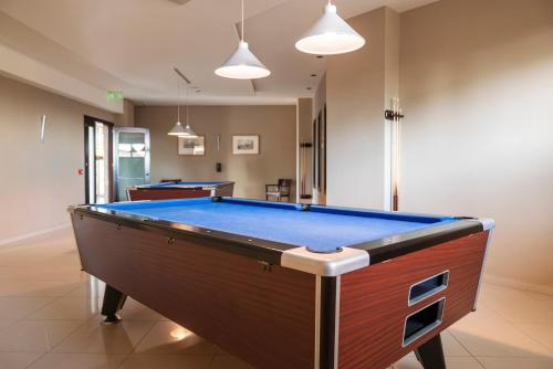 a room with a pool table in a room at D'Andrea Mare Hotel in Ialyssos
