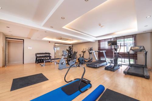 a gym with treadmills and exercise equipment in a building at D'Andrea Mare Hotel in Ialyssos